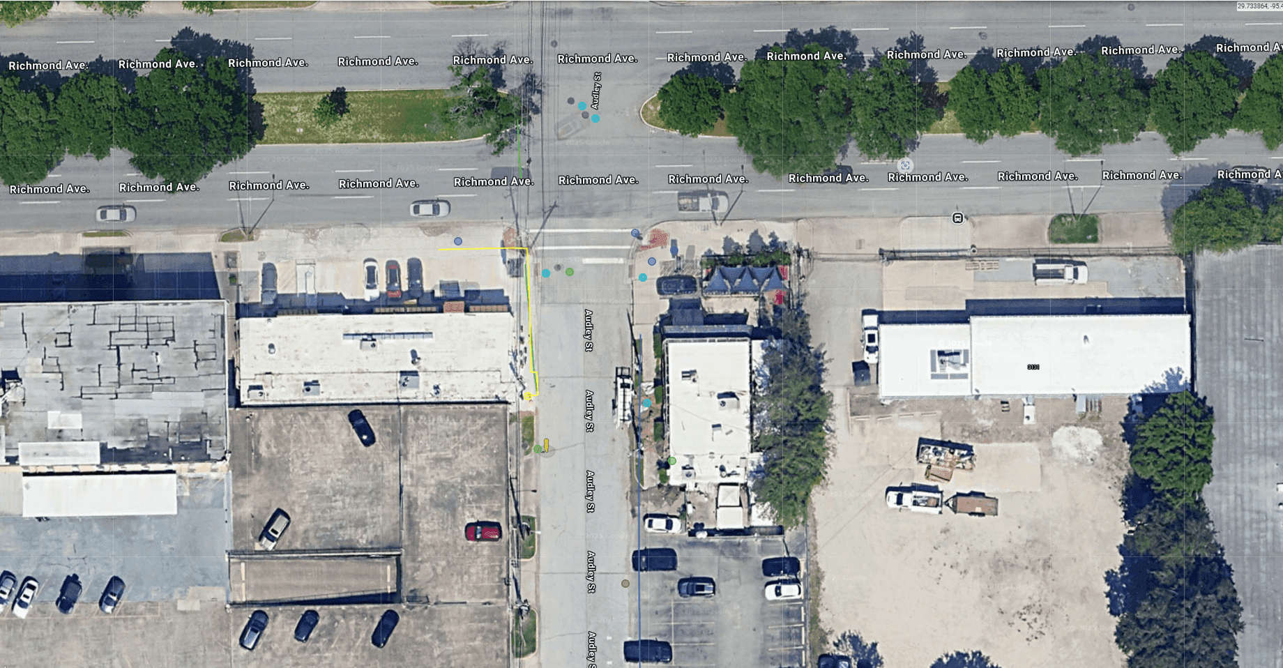 Aerial view of a Houston construction site with utility locating in progress, showing equipment and trench lines.