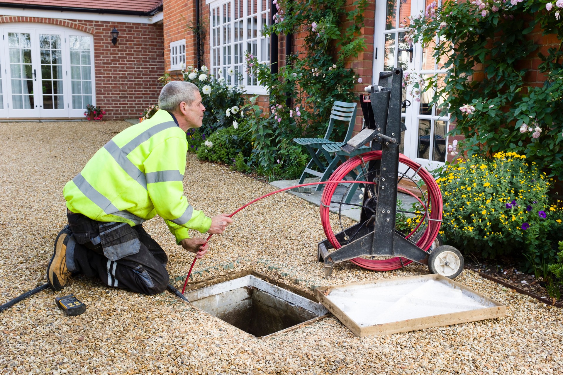 Man unblocking outside drain