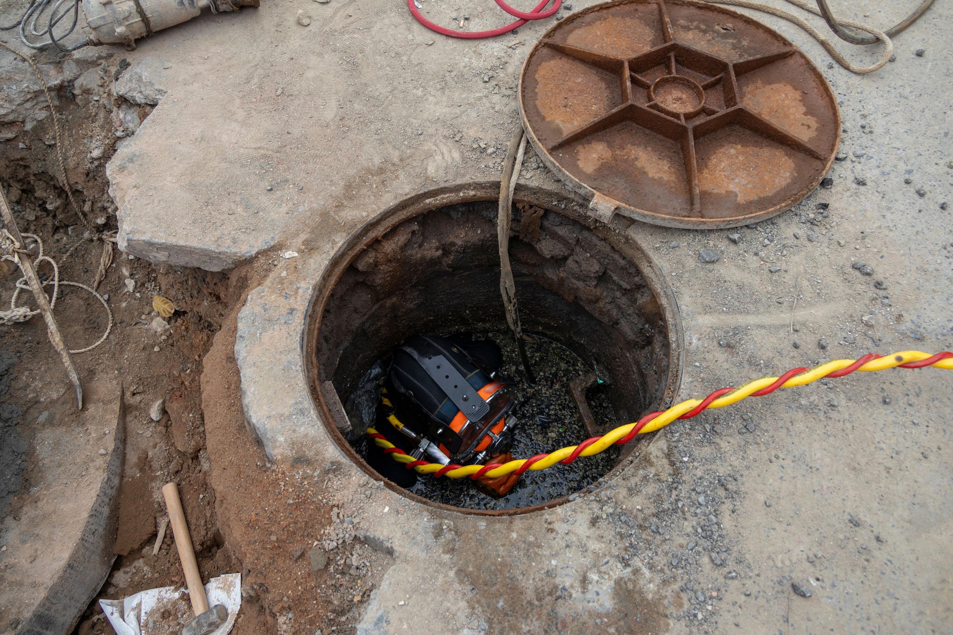 City cleaners clean up sewage from sewage wells